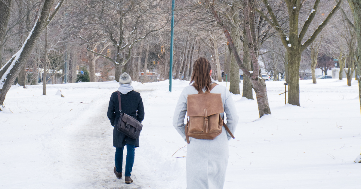 Students walking on campus through the winter snow.